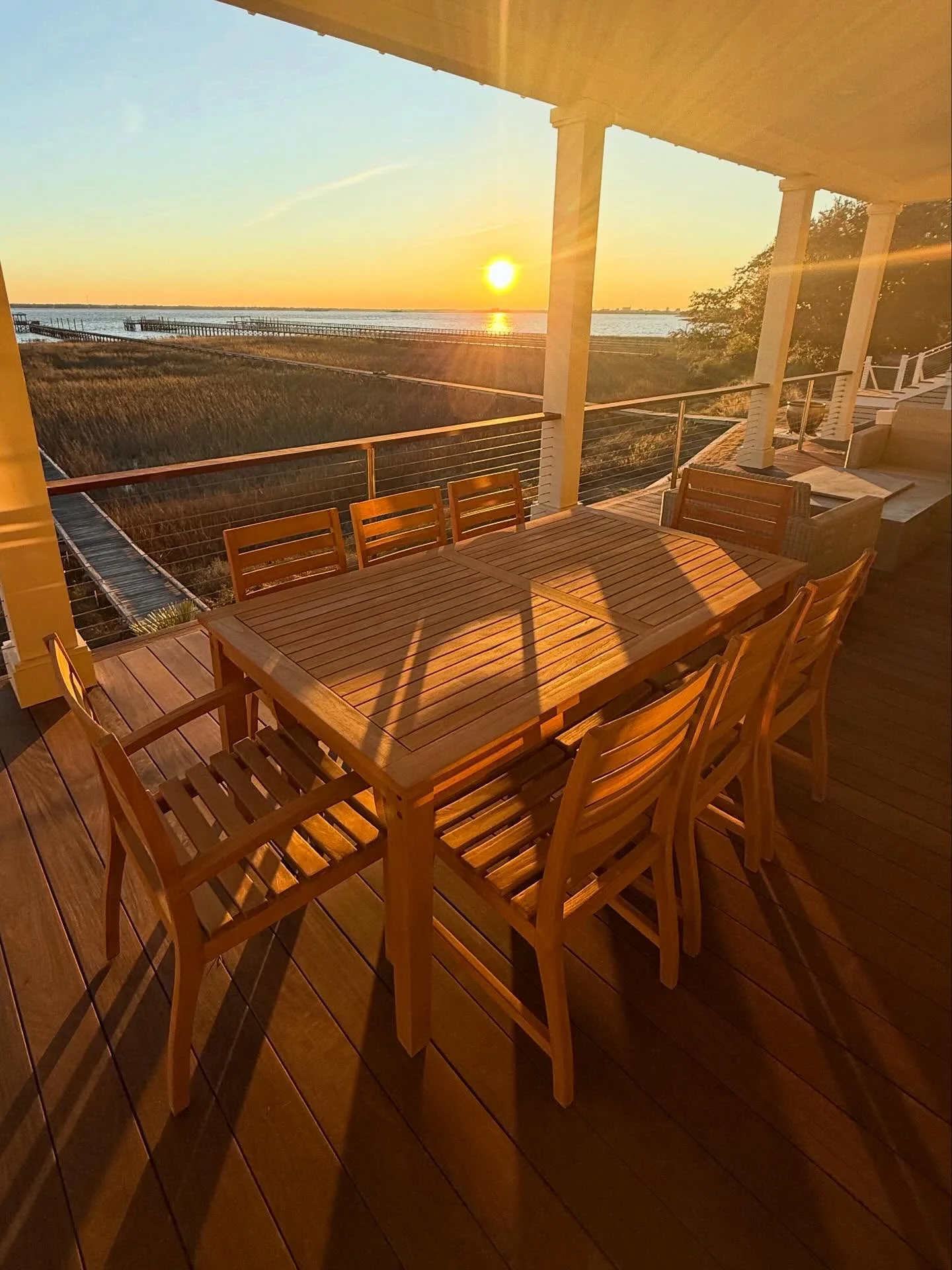 Marine-grade teak table on restored deck at sunset